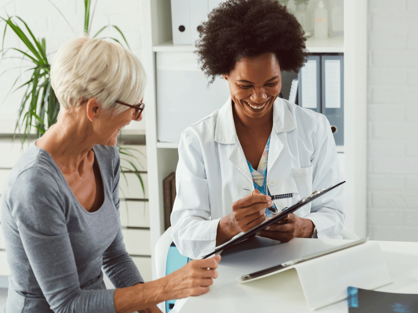 HCP with clipboard and patient