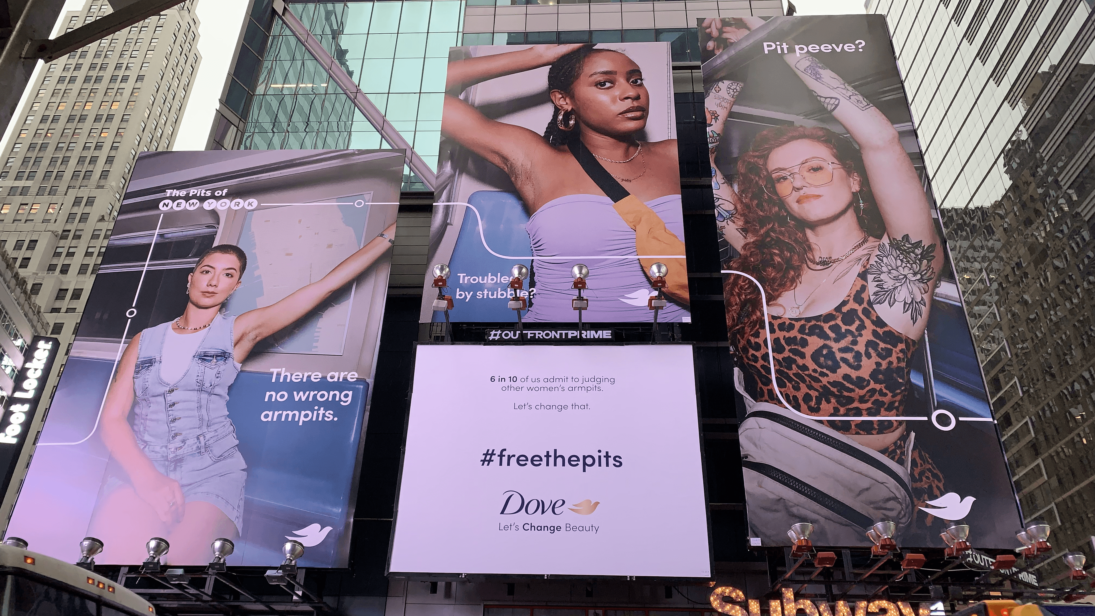A triptych of vertical billboards featuring three different women showing their armpits in a subway setting. The captions include "There are no wrong armpits," "Troubled by stubble?" and "Pit peeve?". Below them, a central billboard displays the Dove logo and the campaign slogan "Let's Change Beauty."